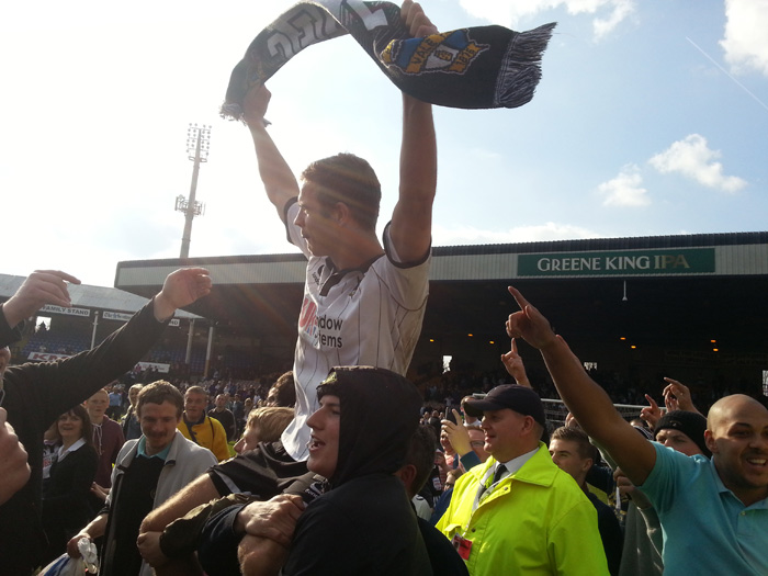 Tom Pope is carried aloft by the crowd - Port Vale v Northampton Town 2013