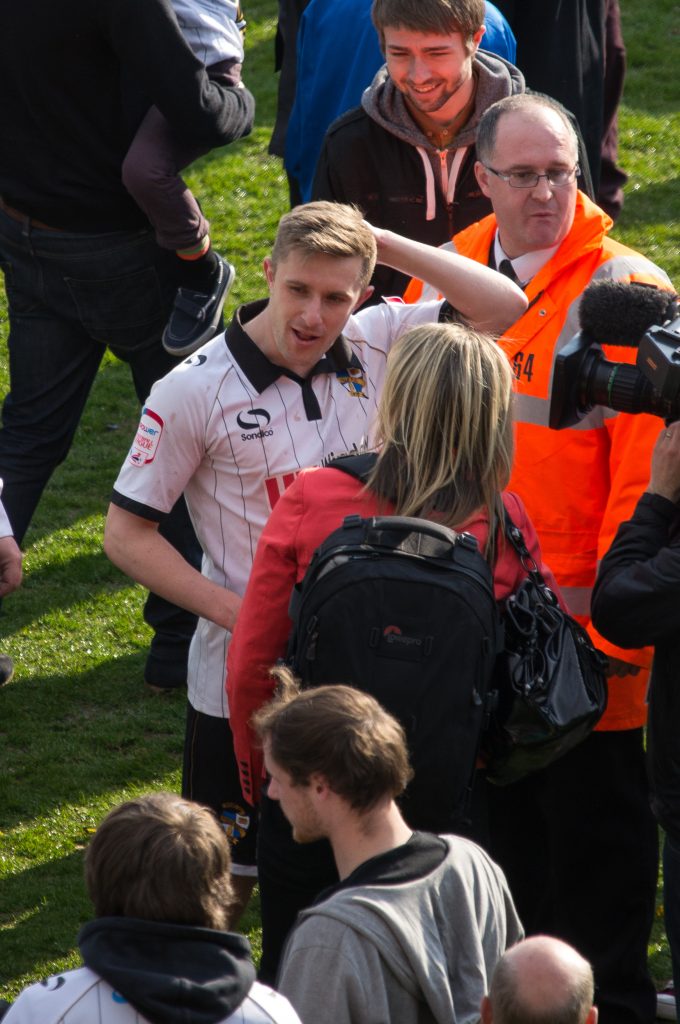 Port Vale defender Adam Yates celebrates promotion