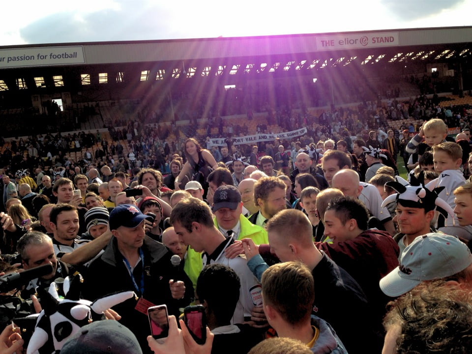 Tom Pope is interviewed as fans pack the pitch - Port Vale v Northampton Town 2013