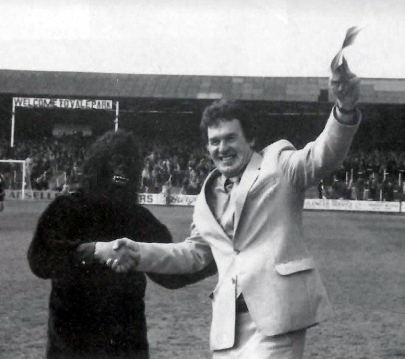 John McGrath celebrates with a Port Vale fan in fancy dress as the club celebrate promotion in 1983