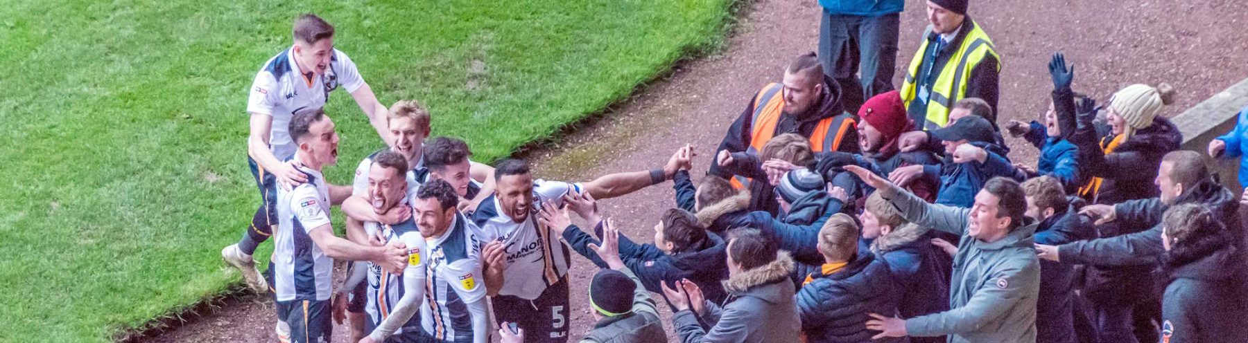 Port Vale players and fans celebrate Ricky Miller's goal against Mansfield Town
