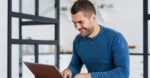 smiley-man-working-laptop-from-home smiley-man-working-laptop-from-home