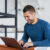 smiley-man-working-laptop-from-home
